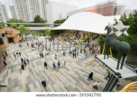 HONG KONG, CHINA - FEB 10: Many people and families relaxing and listening street music on a square during holidays on February 10, 2016. There are 1,223 skyscrapers in Hong Kong.
