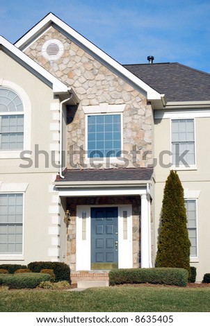 typical american suburban single family house with blue door
