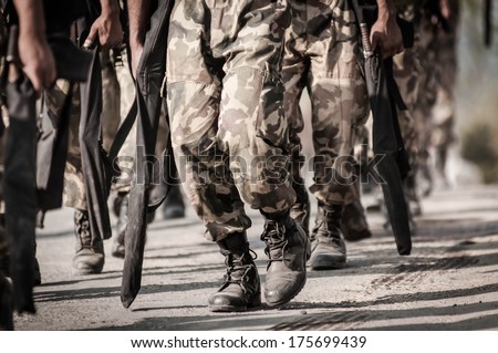 running soldiers carrying weapons