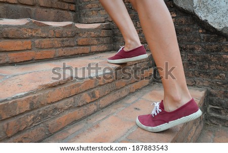 Stepping on an old red brick stairs in ancient Temple