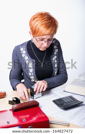 woman counts taxes on a white background