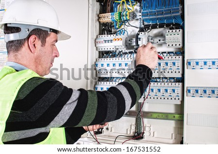 Electrician Checking A Fuse Box