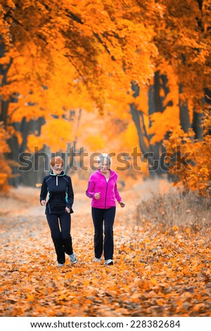 Mother and daughter running around in the park