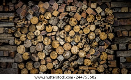 Background of dry chopped firewood logs in a pile