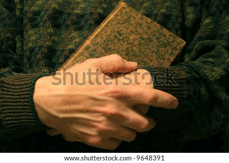 Holding a old and loved book.