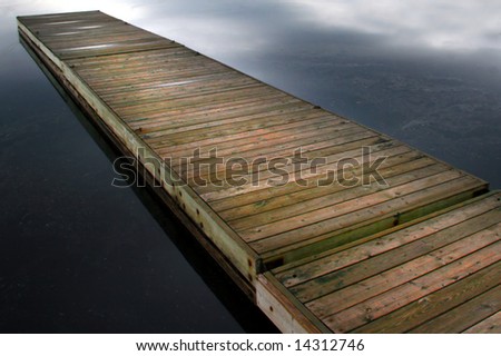 Floating wood boat dock at a lakeside cottage