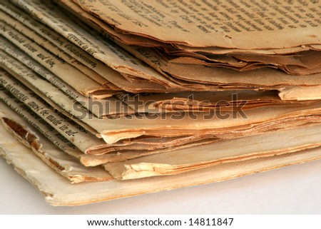 Old newspapers, yellowed, brown, and brittle.