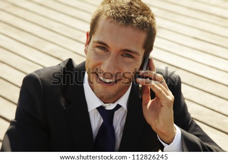 he is calling somebody by mobile telephone on the street