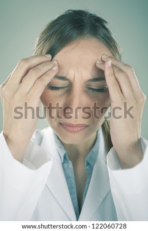 Stress woman young doctor. Medical woman with headache