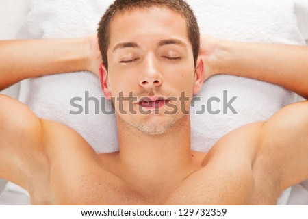 Young man resting after a massage / Handsome man relaxed in spa