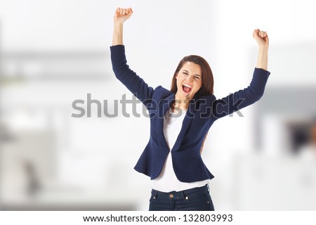 Success yong business woman celebrating screaming. Caucasian businesswoman cheerful for her success at the office