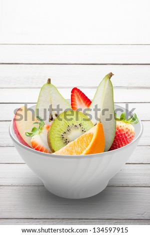 Close up image of healthy colorful fruit/ Fresh fruits in a white bowl isolated