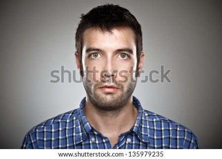 Portrait of a normal boy over grey background. / Young man face, high detailed portrait.