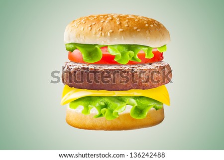 Classic hamburger on brown background / Big hamburger with fresh ingredients.