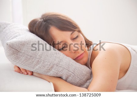 Portrait of a young woman sleeping on the bed. A woman resting in bedroom