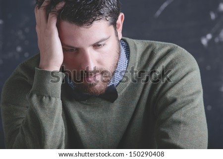 The teacher. Stressed teacher man in front a blackboard.