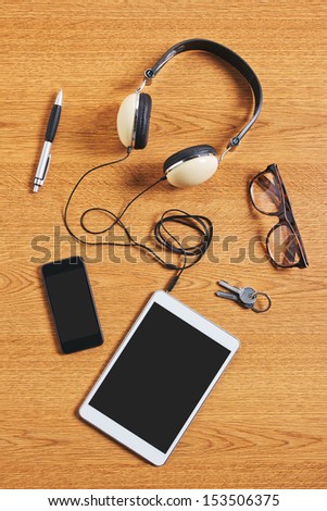 Composition Of Tablet, Phone And Headphones On A Desk. Different Business Objects.