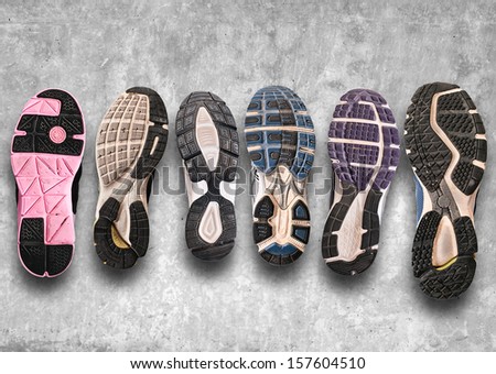 Variety of shoes./ Different shoe sole on a grey background.