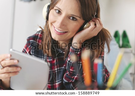Young Creative Woman Listening Music With Headphones, / Casual Blogger Woman Working Digital Tablet In Fashion Office.