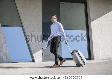 Handsome man reading a newspaper on a grunge background/  Businessman walking with bag to the convention.