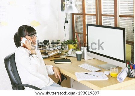 Beautiful businesswoman smiling./ Young entrepreneur woman using cellphone on home office.