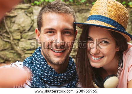 Beautiful couple smiling in your home garden./ Selfie photo of a young couple enjoying day in outdoors.