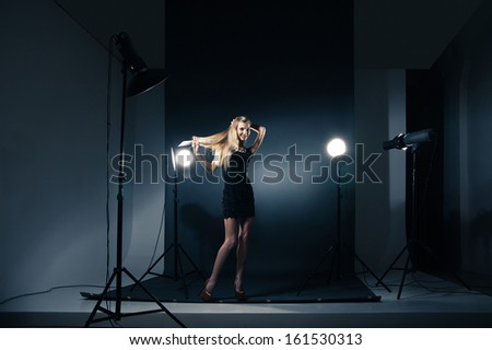 Beautiful Female Model Posing At Studio In The Light Flashes