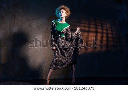portrait of fashion women in green dress and with red lips abstract dark background