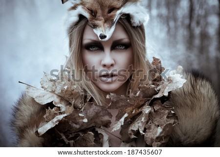 Romantic wild beauty tribal woman in fox costume in wild forest. Vintage styled