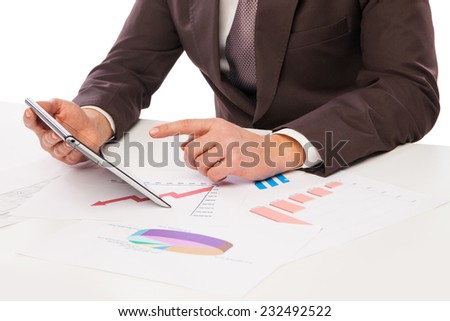 Businessman using tablet PC in office isolated over white. Draft on table
