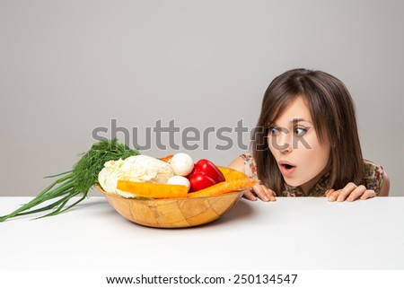 woman looking at green vegan food. surprise emotion.