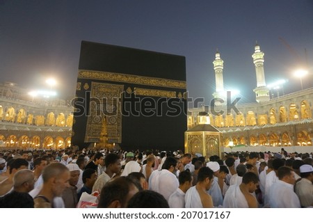 MECCA, SAUDI ARABIA - JUNE 7: Muslim pilgrims, from all around the World, revolving around the Kaaba on June 7, 2013 in Mecca, Saudi Arabia. At Night scape