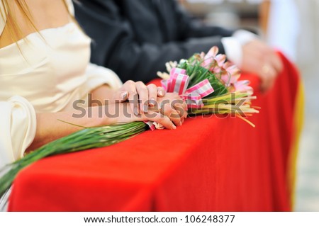 Bride holding wedding bouquet during wedding ceremony