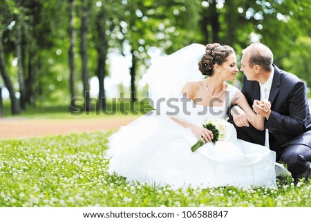 Happy bride and groom in a park. Wedding couple