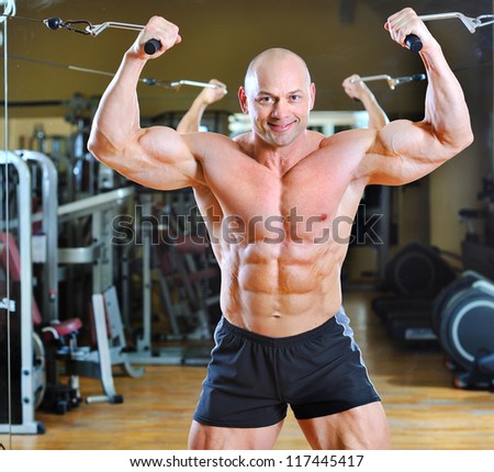 Bodybuilder posing at gym - strong man torso