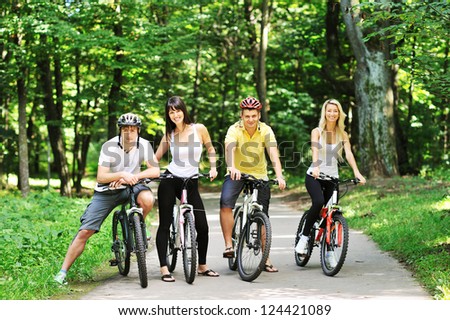 Group of four adults on bicycles in the countryside