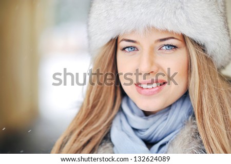 Close up of a beautiful girl face in winter fur hat