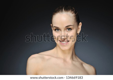Young woman with beautiful healthy face - dark background