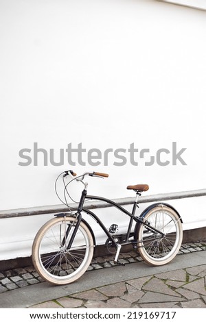 Vintage cruiser bike standing near a white wall in an old town