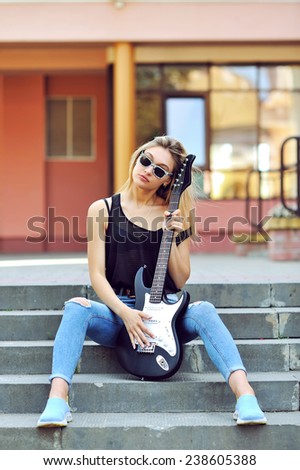 Sexy blonde woman with electric guitar