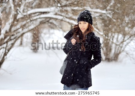 Portrait of a young woman in winter park