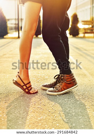 Couple in love. Male and female legs closeup