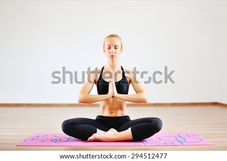 Young beautiful woman in the prayer position