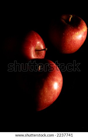 still life image showing three apples in line