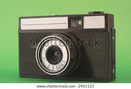 vintage compact camera placed over green