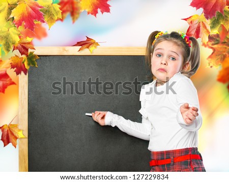 schoolgirl wrote in chalk on the chalk board, on an abstract background