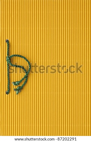 Yellow paper notebook cover bound with green cord