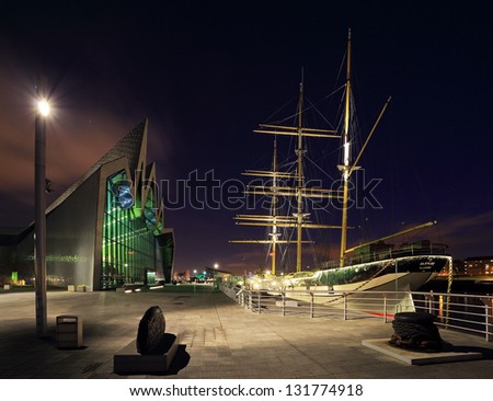 GLASGOW, SCOTLAND - JANUARY 01: the front of the Riverside Museum lit up at night and the Glenlee river boat on January 01, 2013 in Glasgow, Scotland.  The Riverside Museum opened in June 2011.
