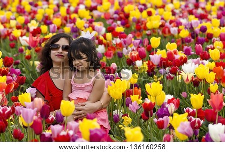 Mom and daughter in tulip garden