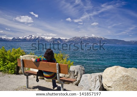 A woman watching beautiful  lake tahoe